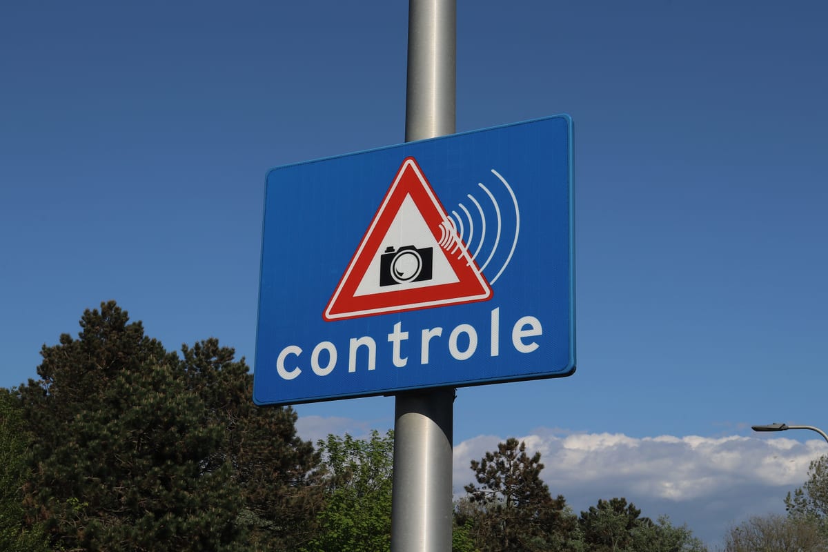 Roadside sign carrying a camera symbol warning drivers that camera monitoring is in use